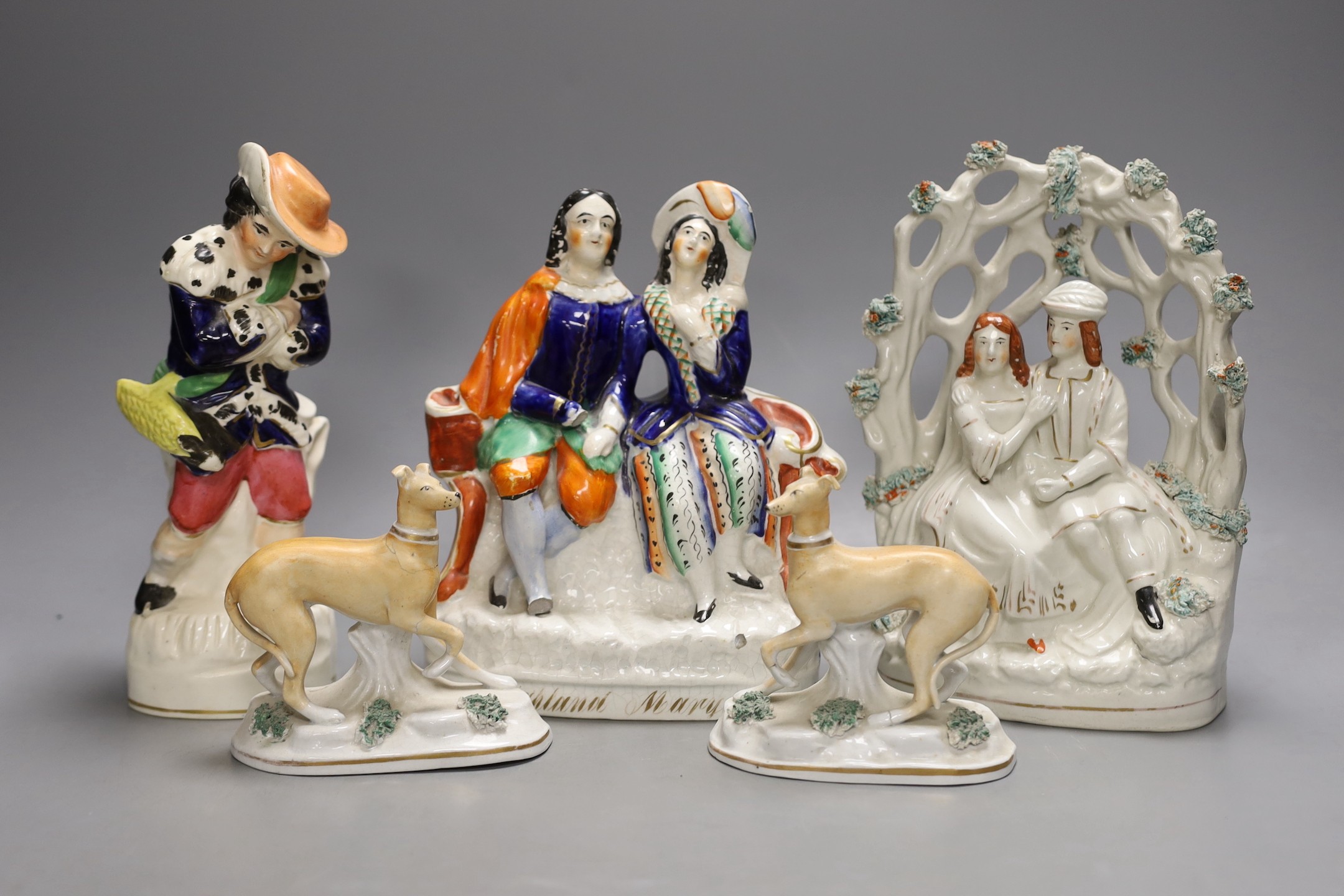 A pair of Victorian Staffordshire greyhounds and three Staffordshire pottery figures or groups - tallest 21.5cm